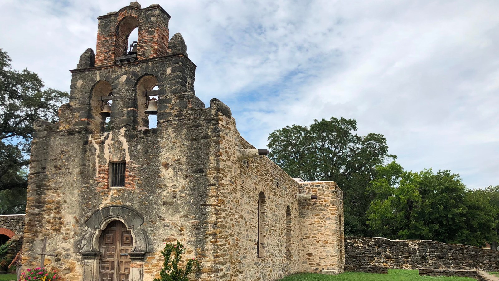 Mission Espada stone church with bell tower.