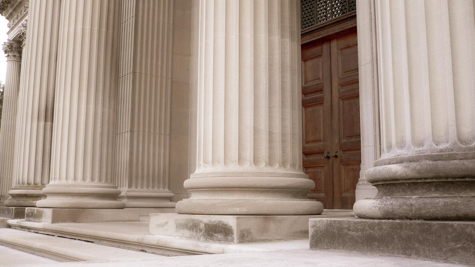 A grand house with large stone columns.