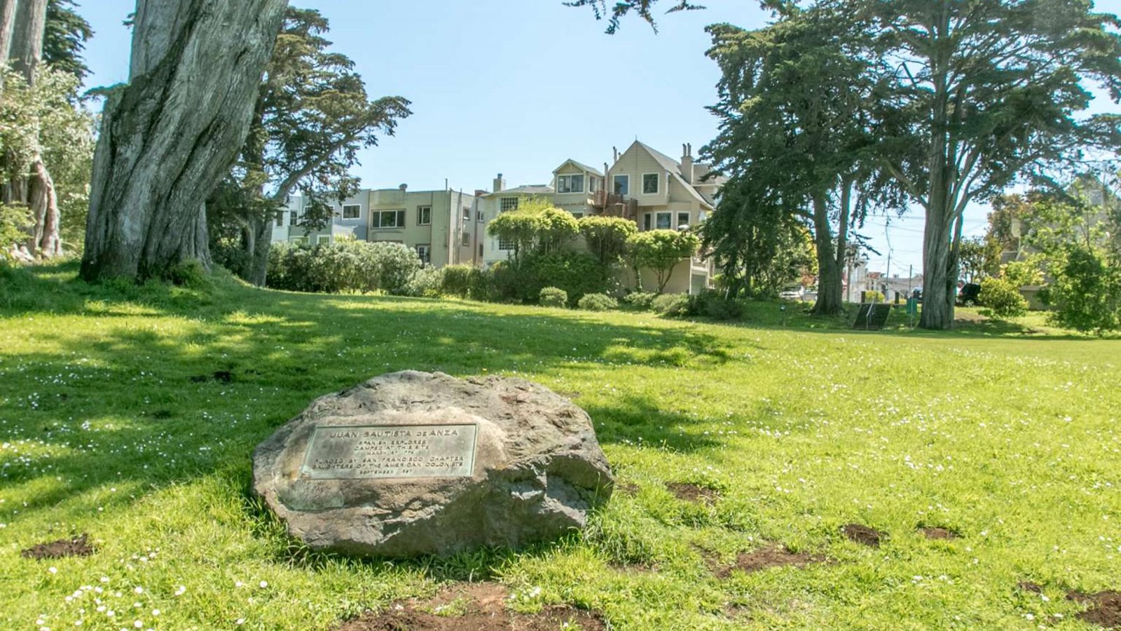 A plaque in a large stone in a grassy meadow marks the site of the first Anza Expedition campsite.