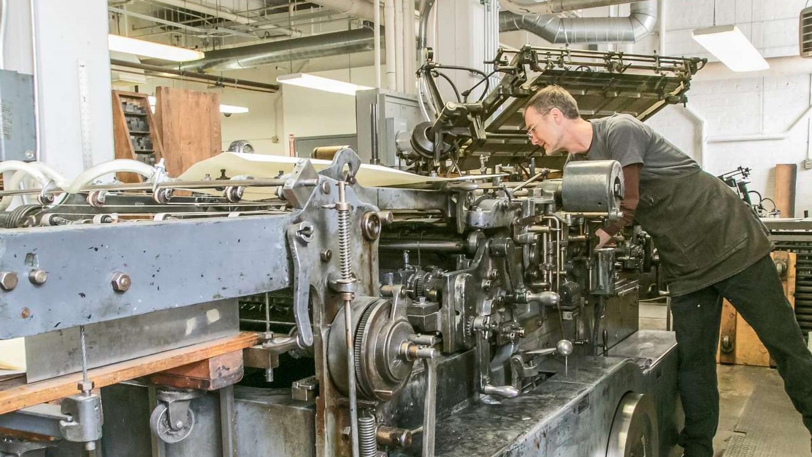 An employee running a printing press