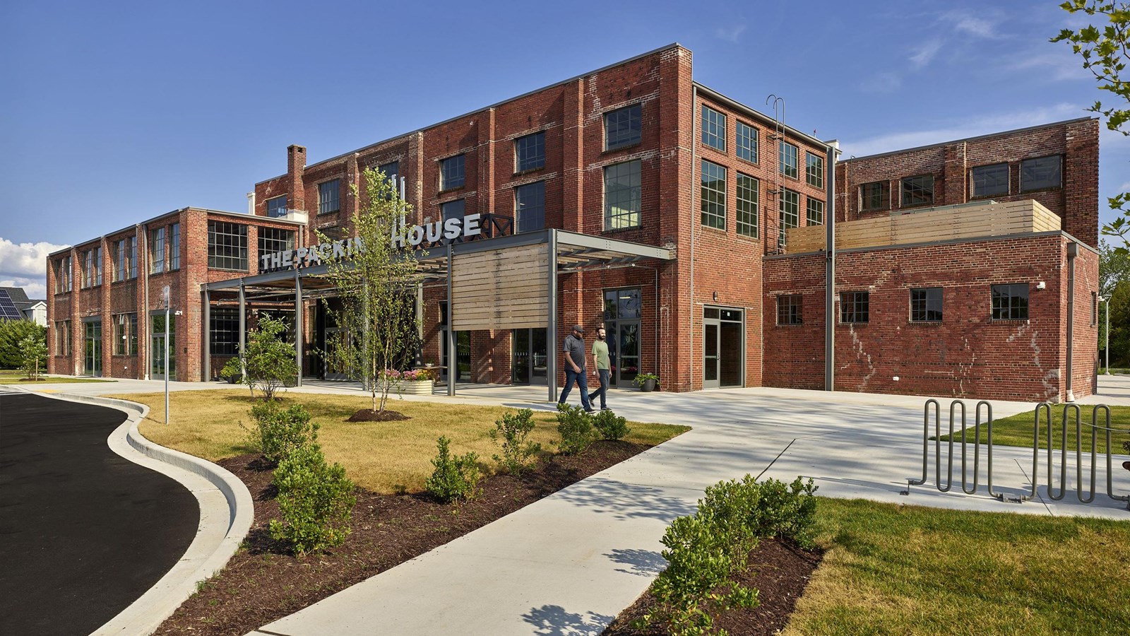 A red-brick industrial building with windows and a 