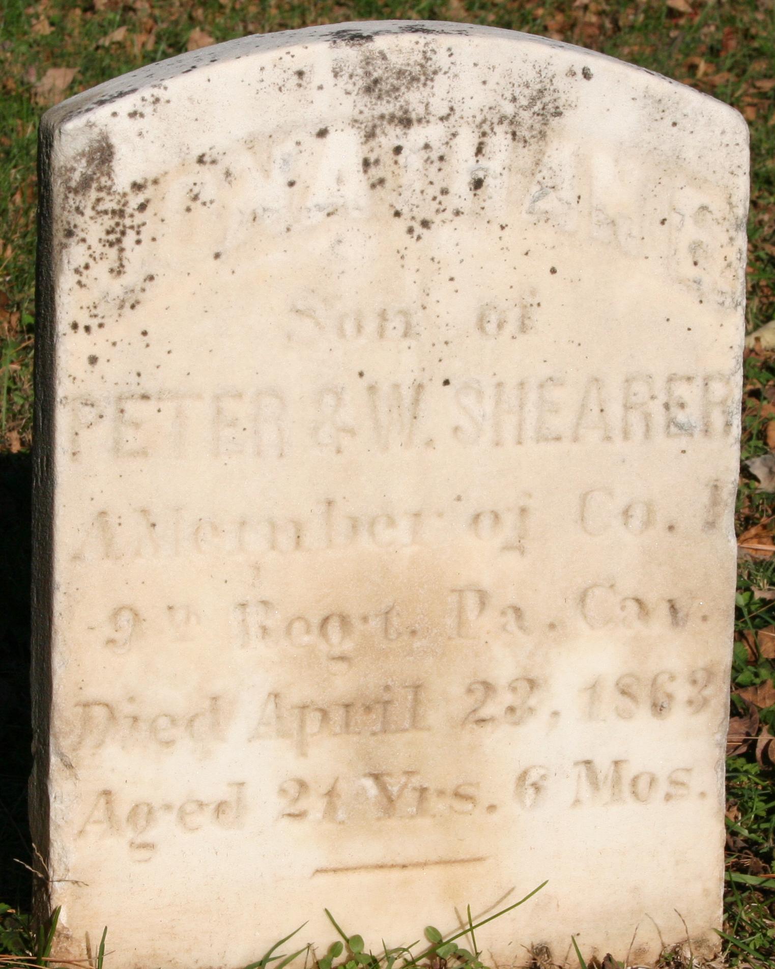Small marble headstone with Jonathan Shearer inscribed on the surface. 