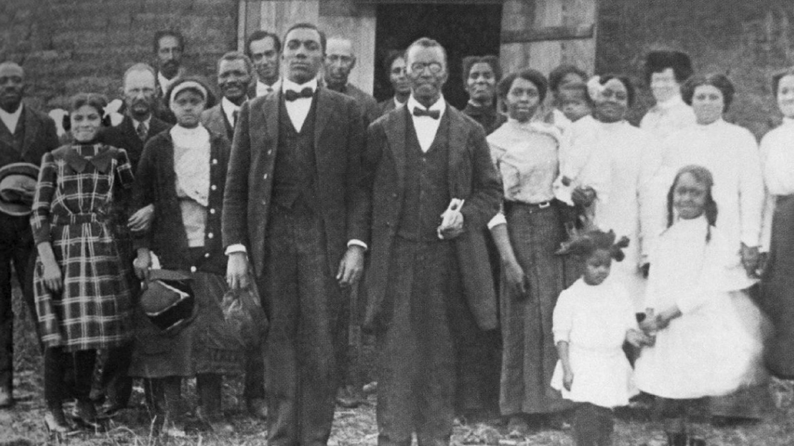 Large group of people standing outside of a church