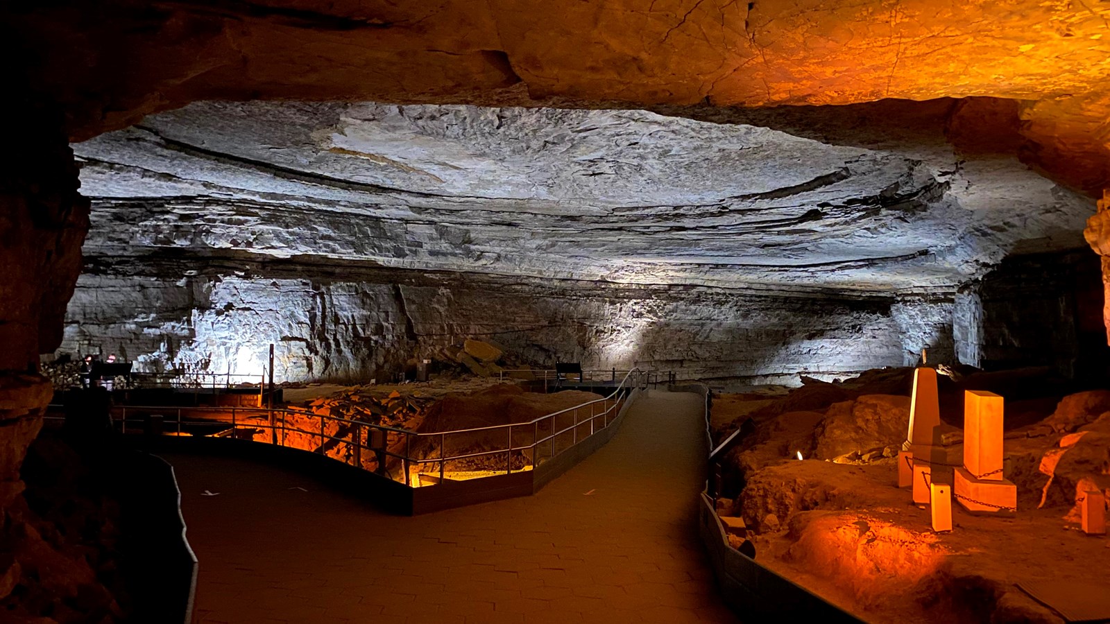 A large open cave room with a round ceiling. The trail splits in a Y here. 