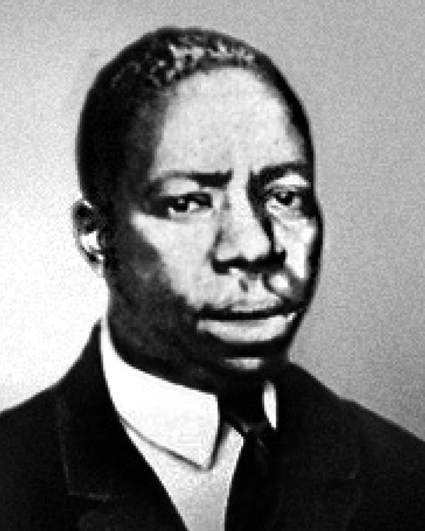 Black and white photo of African American man in suit of the early 1940s