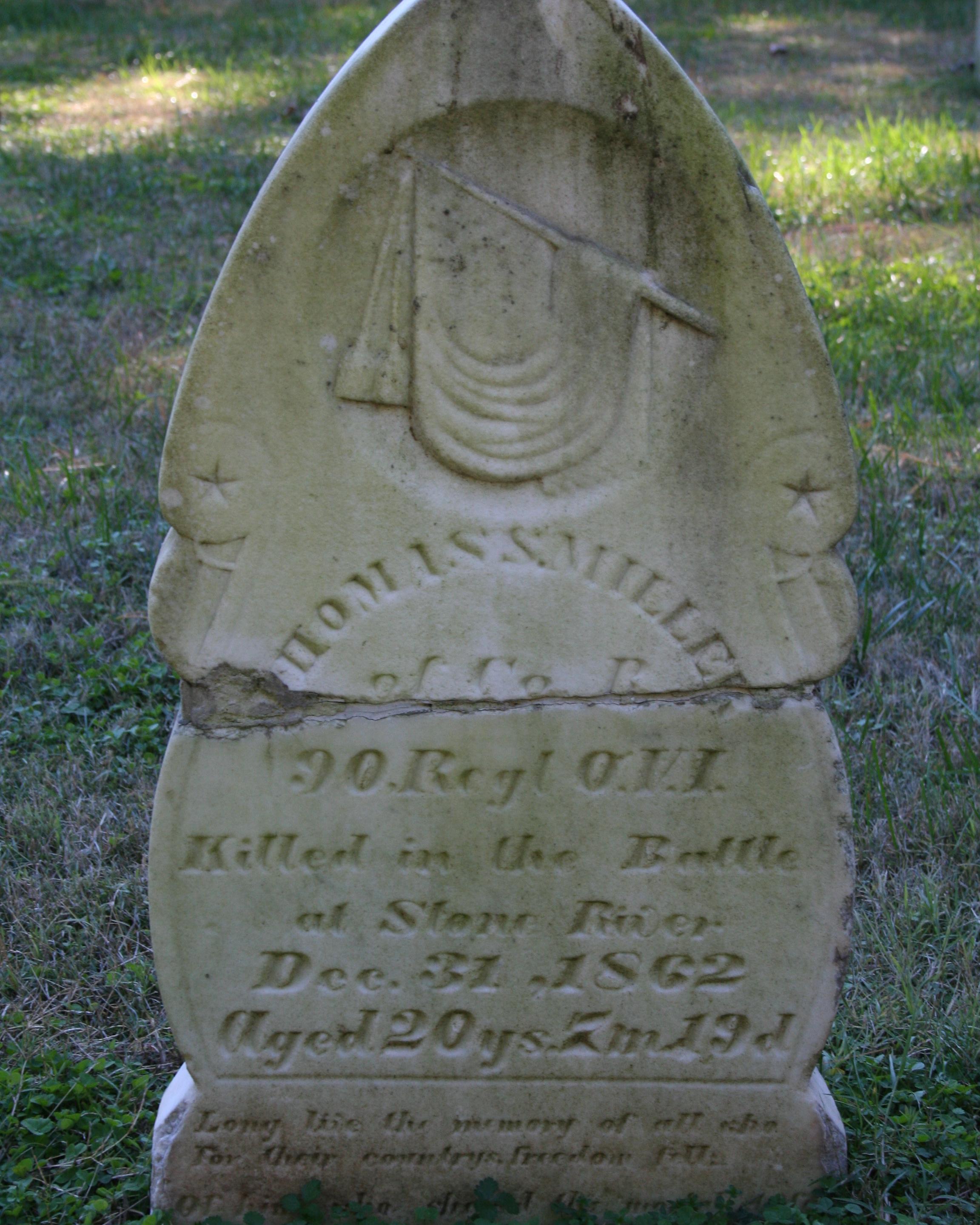 Ornate marble headstone that comes to a point at the top.