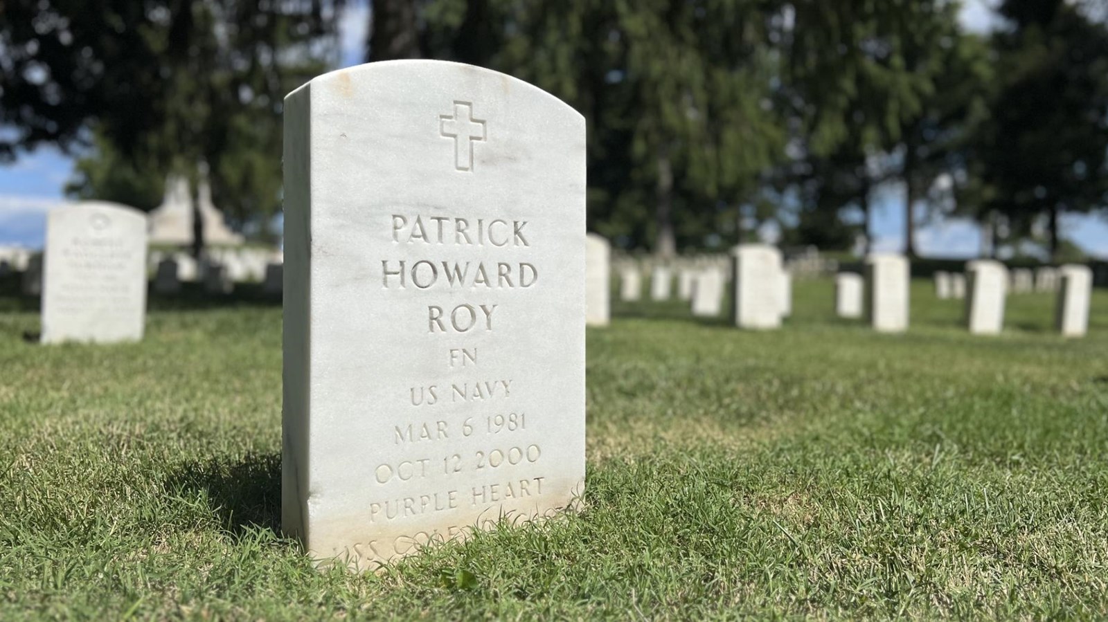 white grave stone with blue sky background