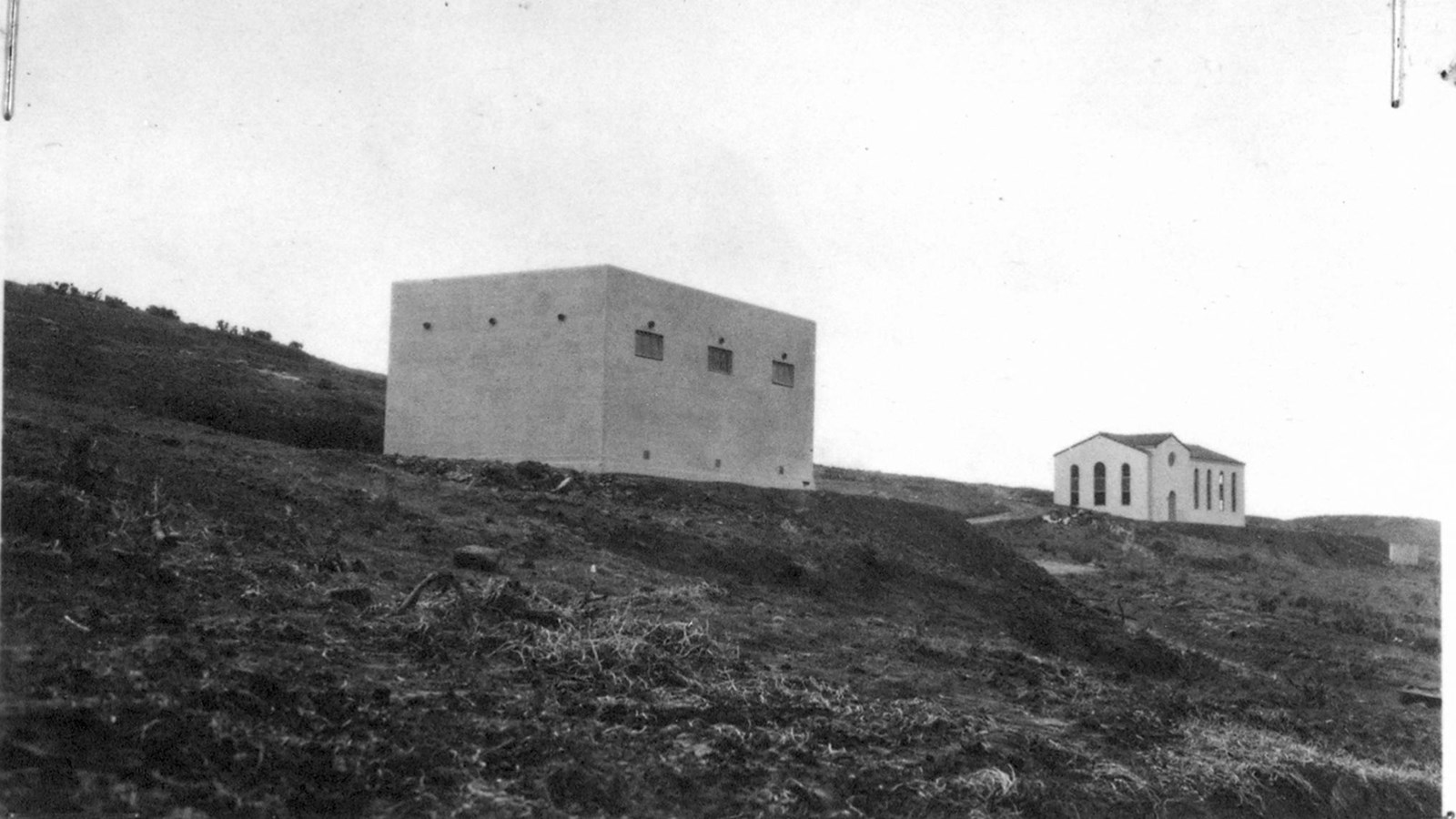 White stucco building on hillside.