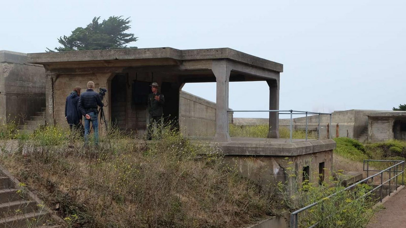 A ranger is standing in one of Battery Crosby\'s gun encampments.