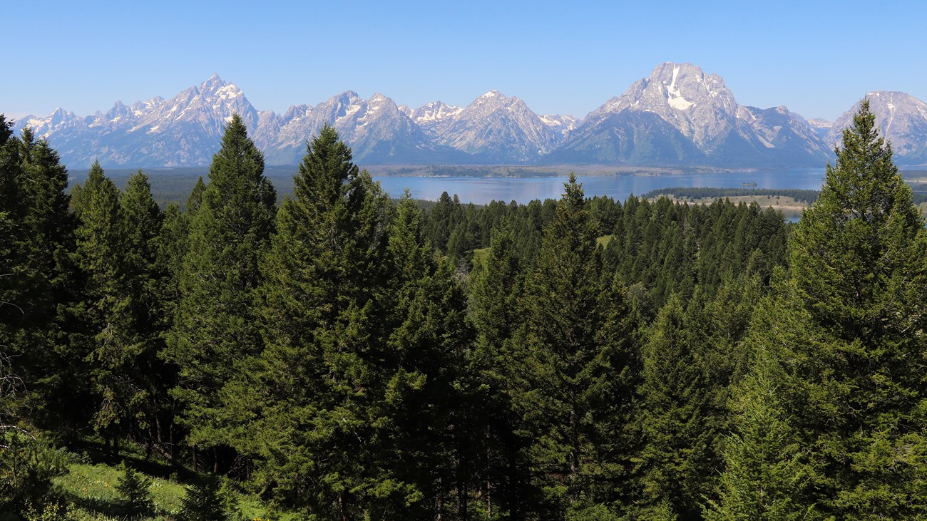 A mountain range and a lake as viewed from a high vantage point.