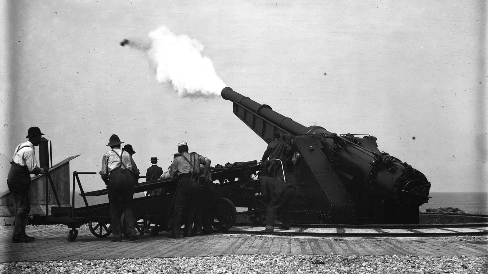 Soldiers firing a round out the battery\'s powerful gun.