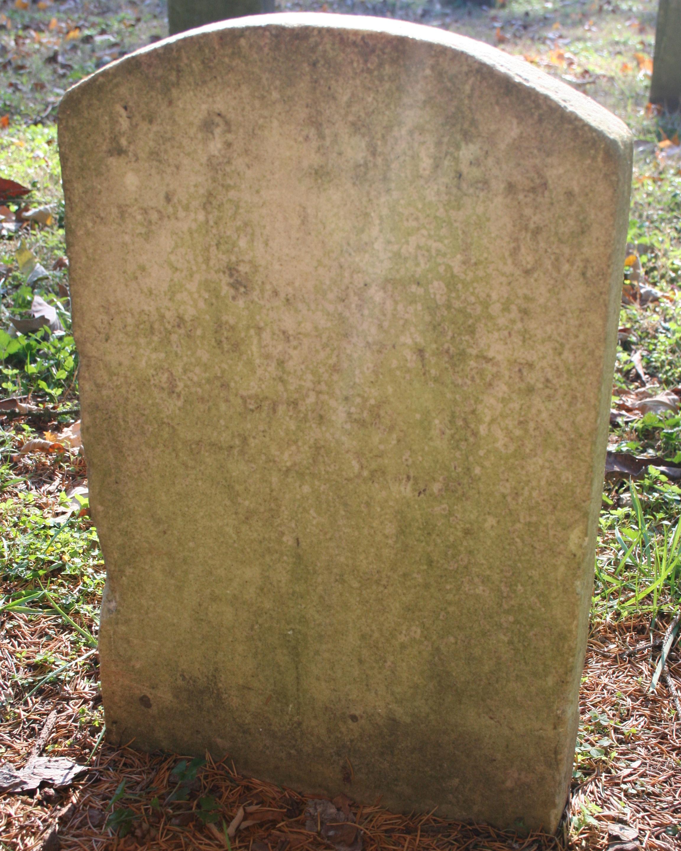Rounded marble headstone belonging to Alexander Andes.