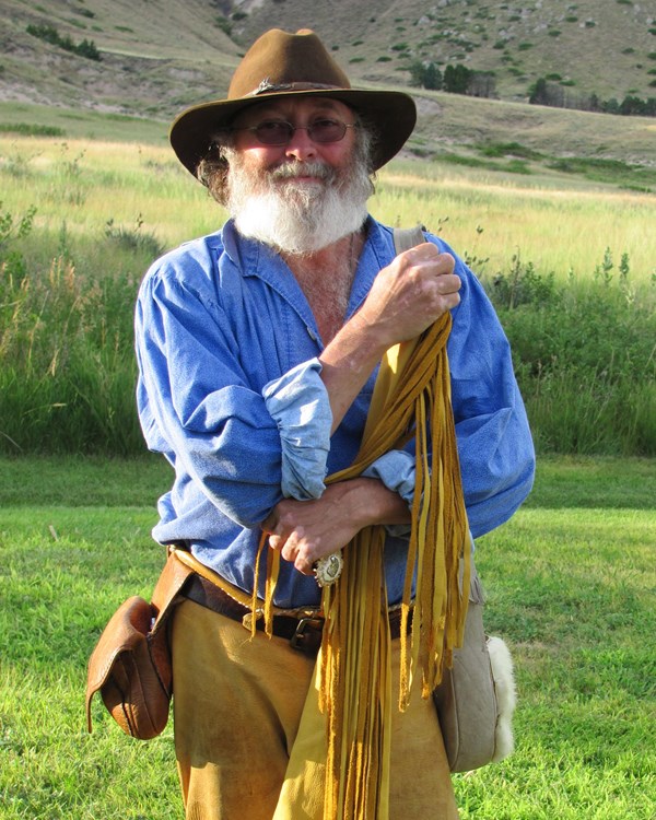 A man is dressed as a fur trader.