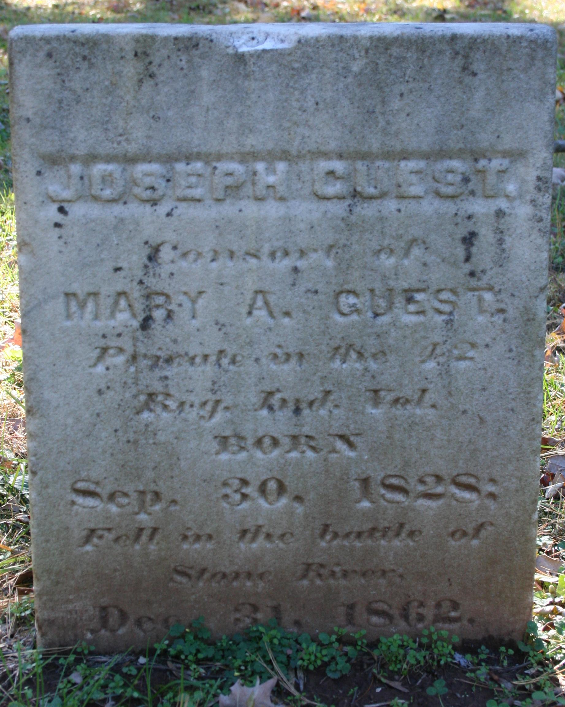 Short, square marble headstone belonging to Joseph Guest. 