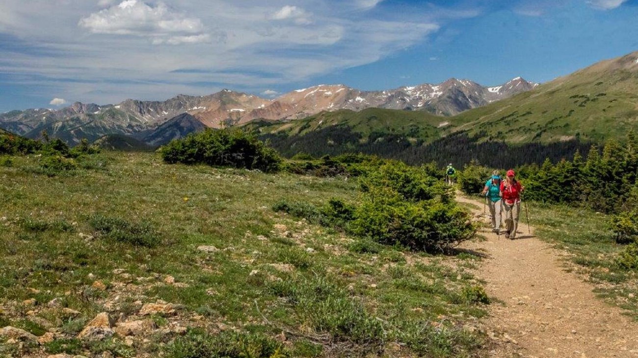 two people hike along a trail