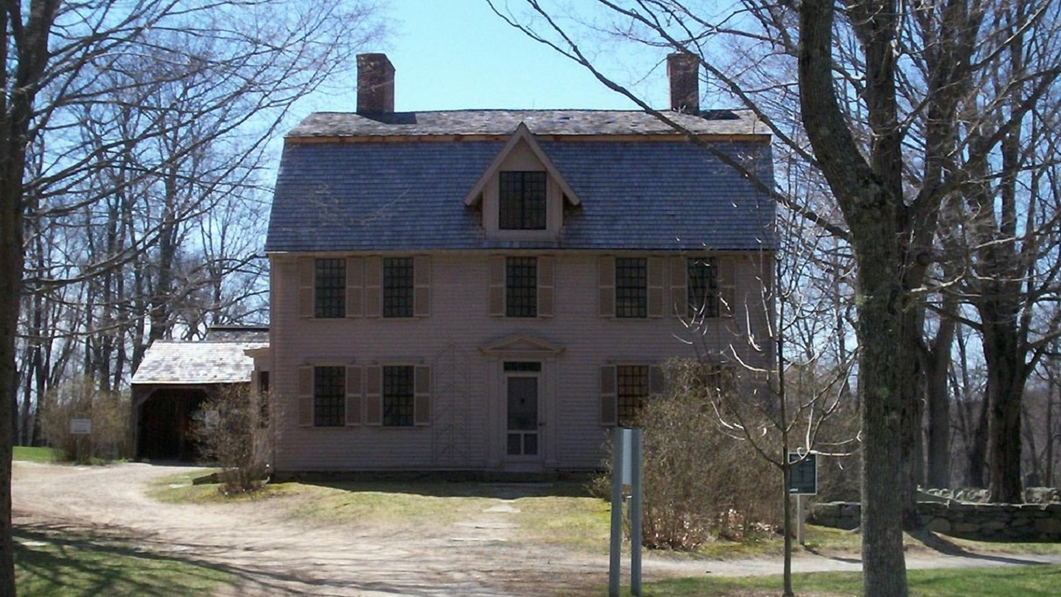 Photo of two-story house with gabled roof. 