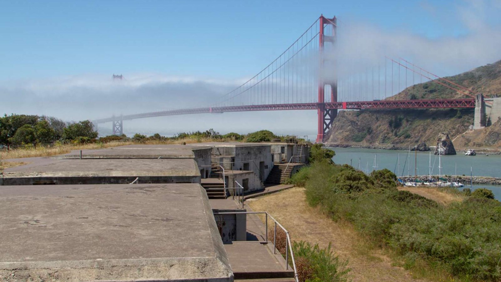 Fog rolls over the Golden Gate Bridge as seen from atop Battery Yates.