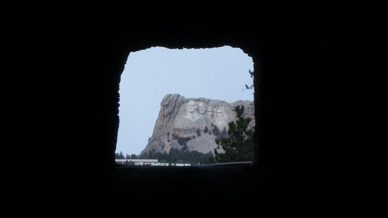 Photo of the view of Mount Rushmore through a tunnel on the Iron Mountain Road.