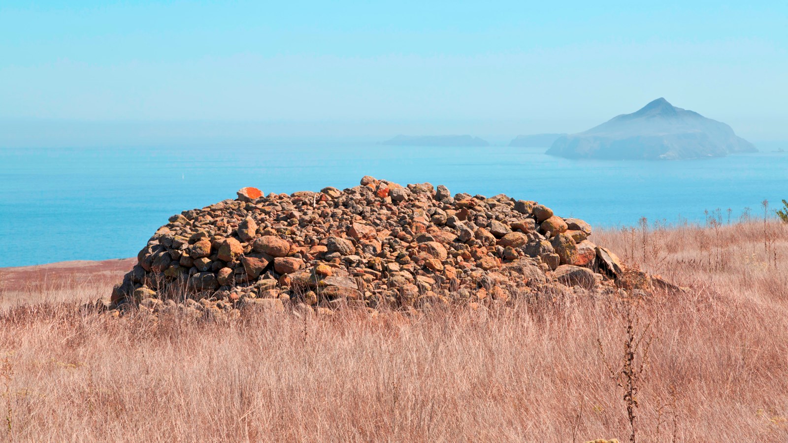 Dotting the open landscape are over 100 large rounded piles of stone