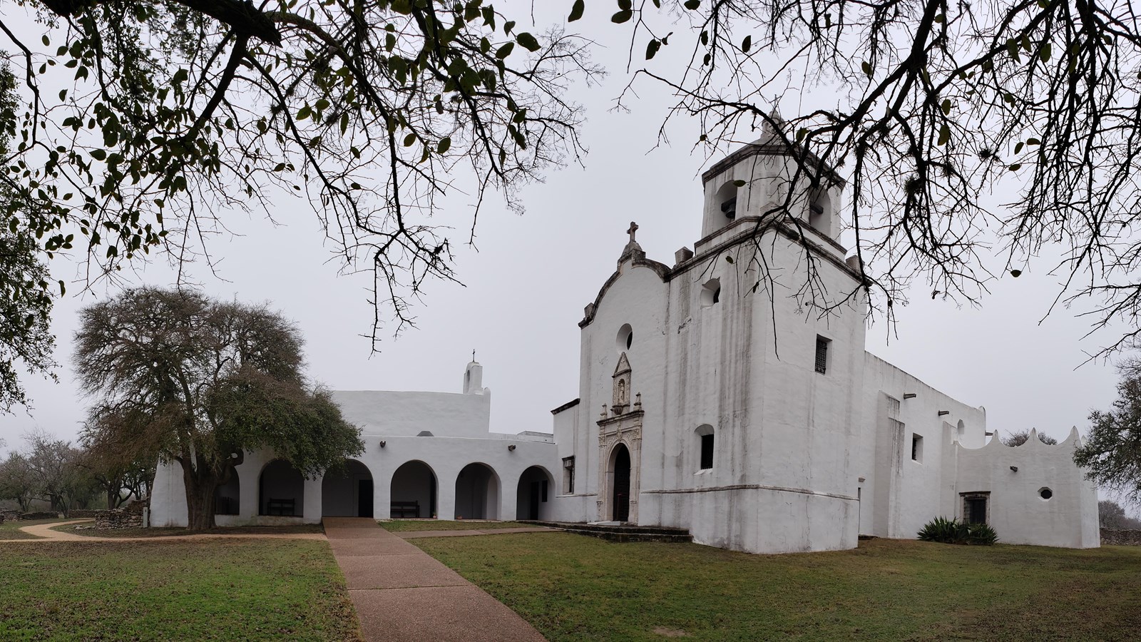 Large white church with connected historical structures.