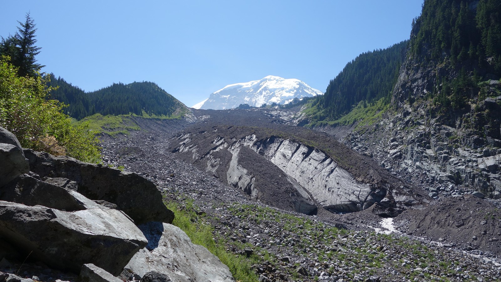 The lower glacier is covered in rocky debris and the ice often looks dirty with sediment 