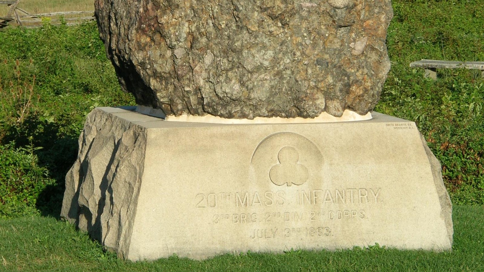 A large boulder on a granite pedestal