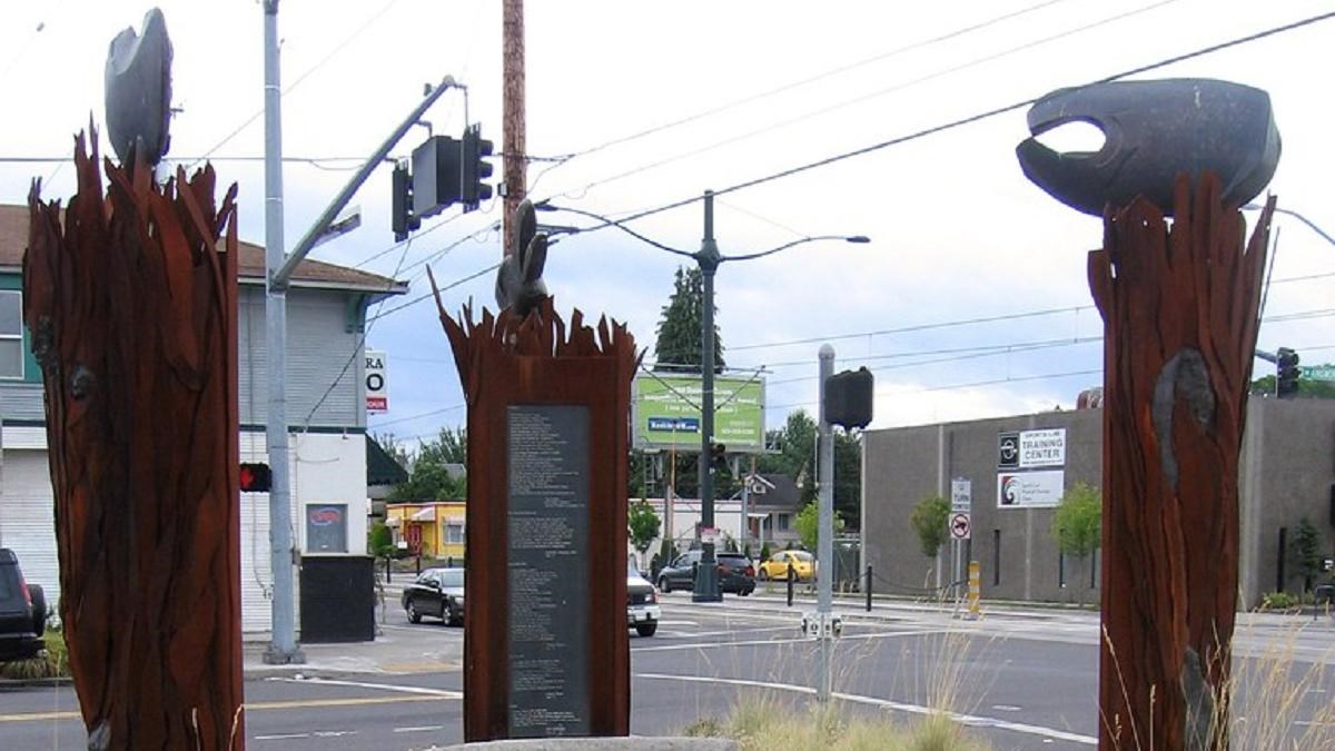 Three statues from native legend look towards each other