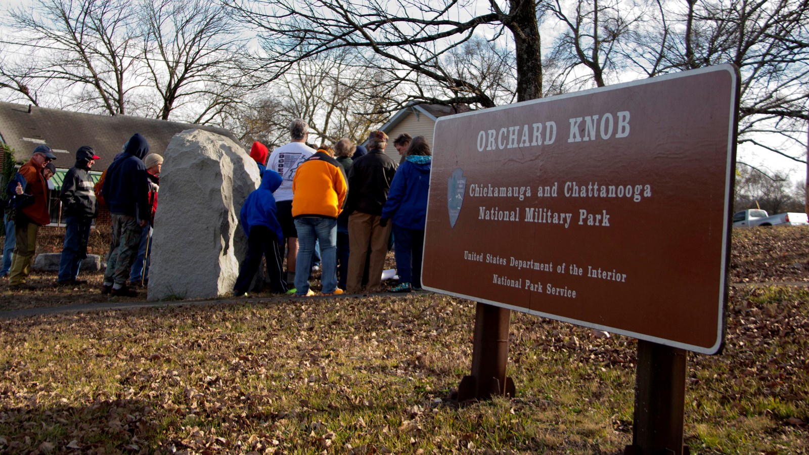 Visitors listen to a ranger-led program on Orchard Knob