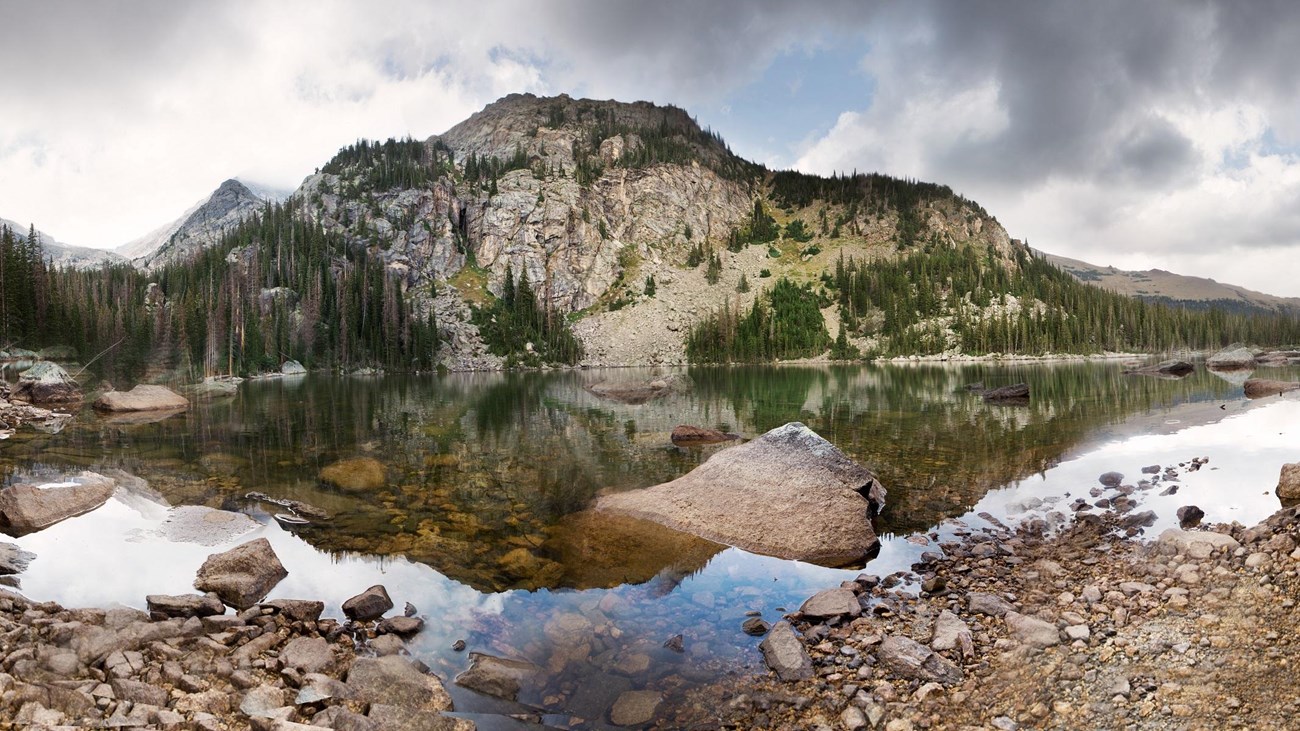 a lake with a large mountain behind it