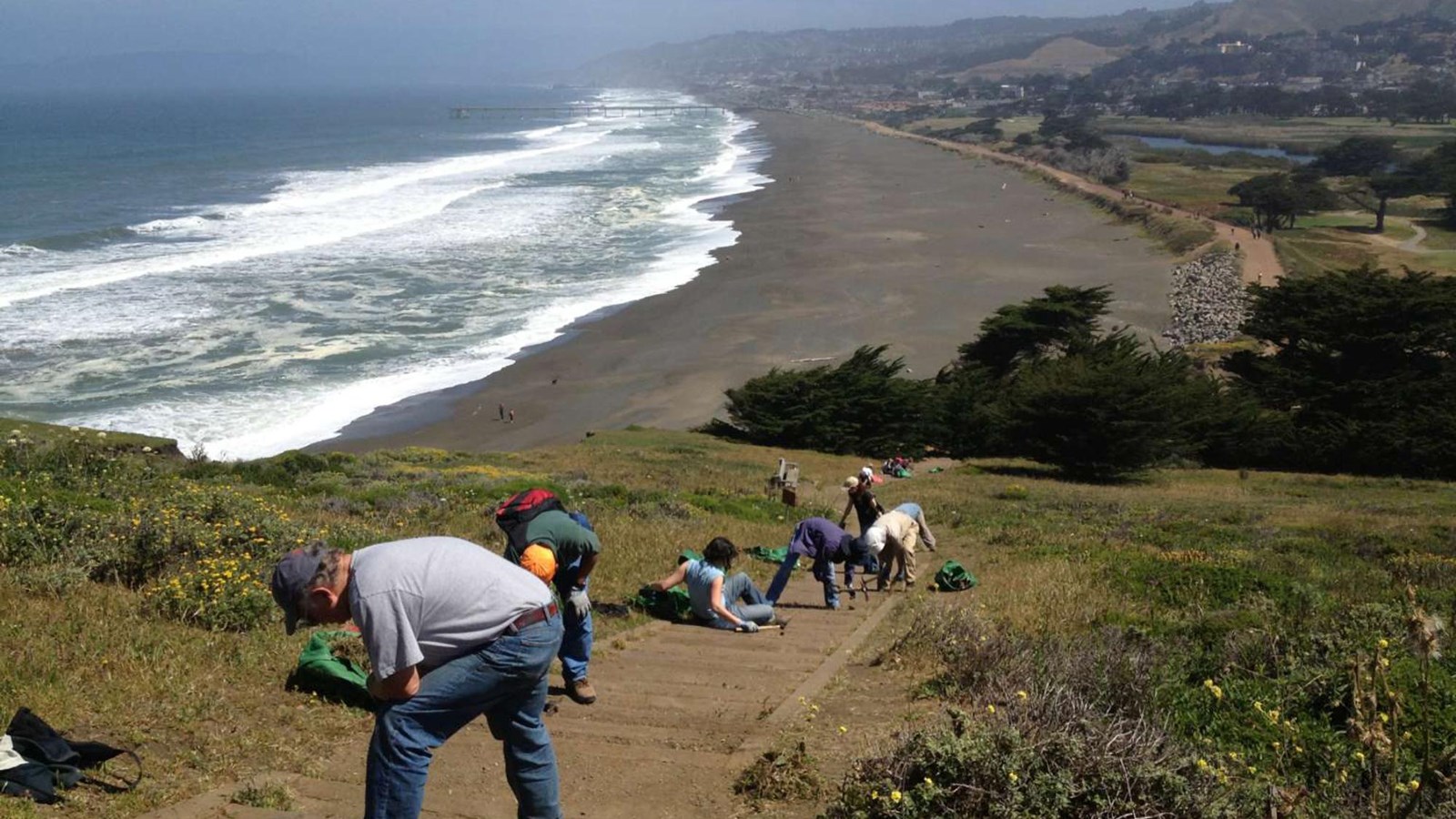 Volunteers and staff from the Stewardship Team weed and repair the steps.