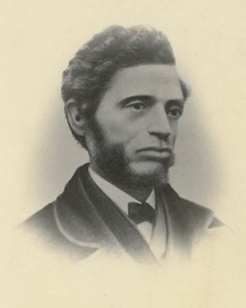 a side portrait of Nell with short wavy hair and side burns