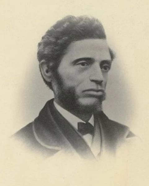 a side portrait of Nell with short wavy hair and side burns