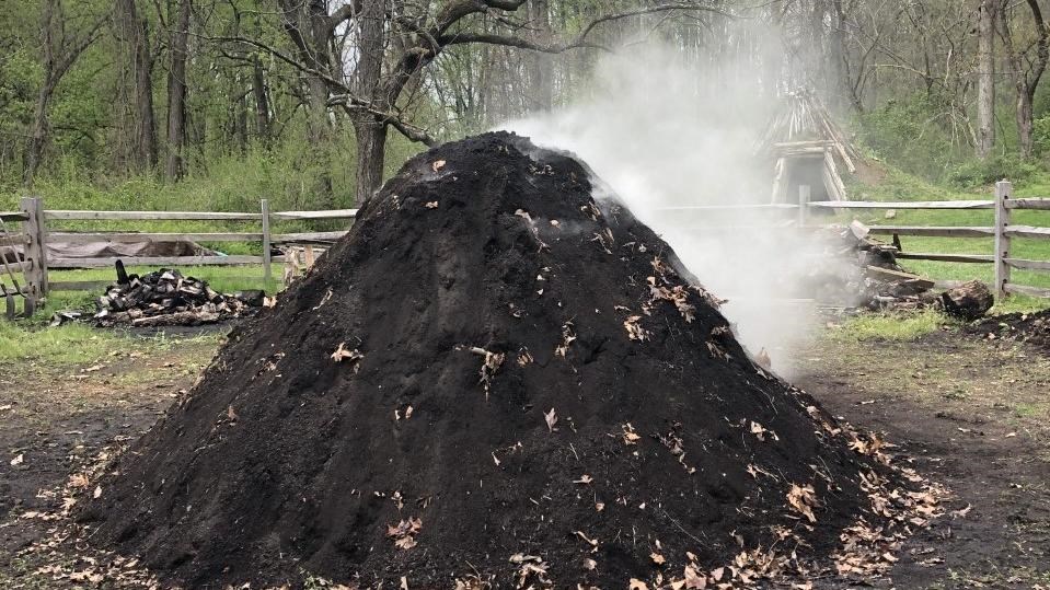 smoking approximately 5-foot-high conical black pile
