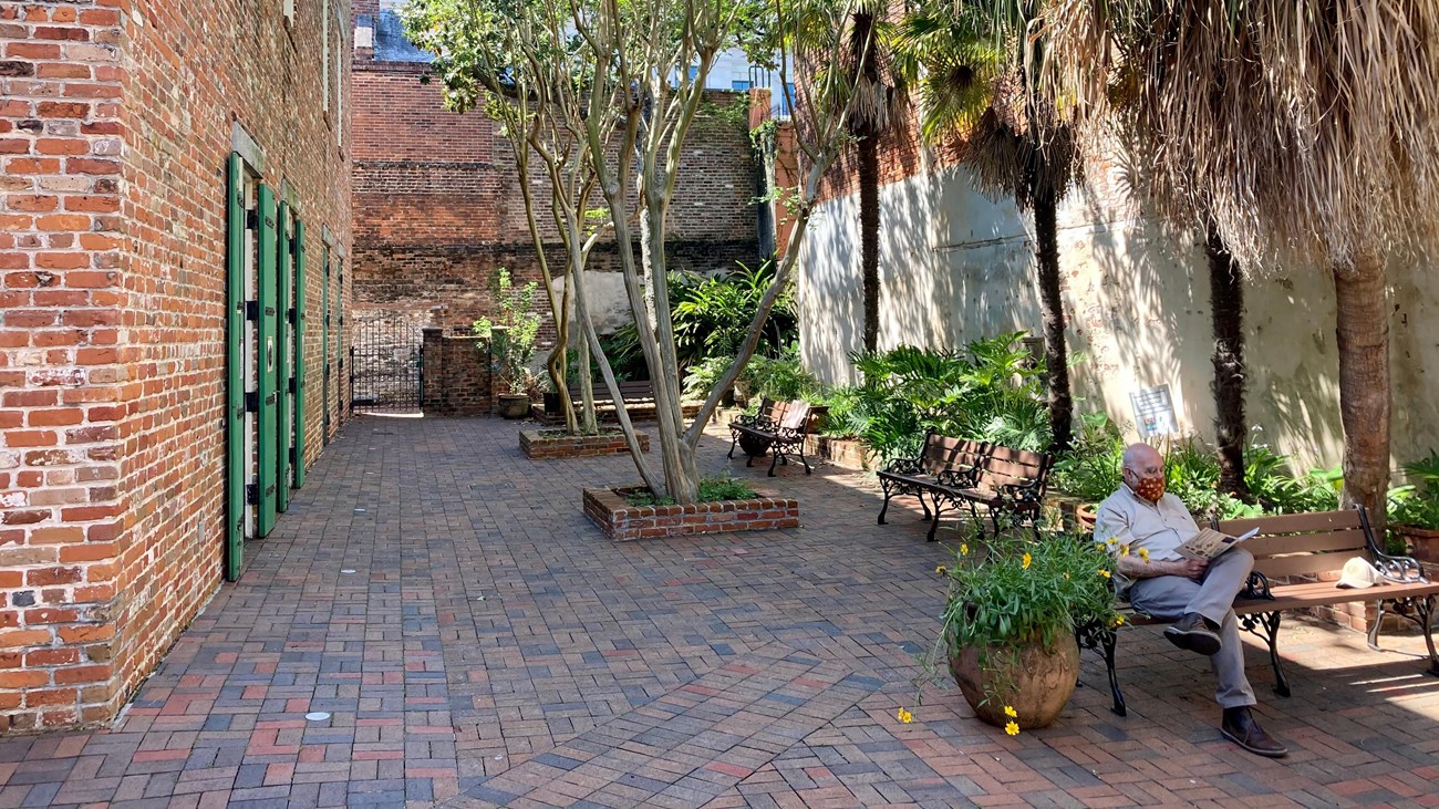 visitor sitting and reading a magazine in our courtyard