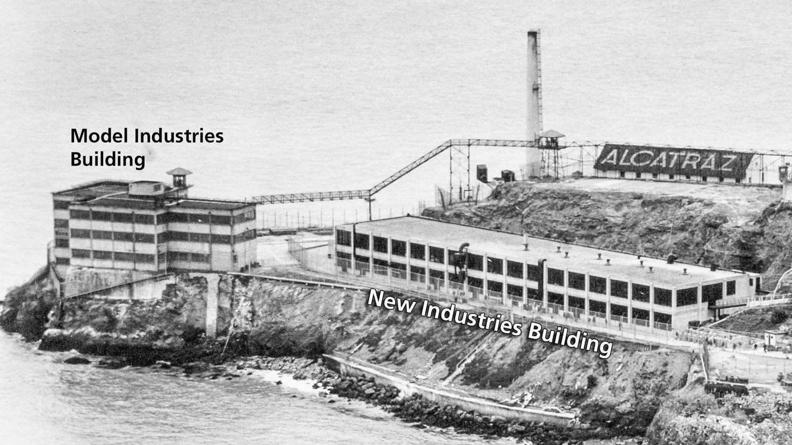 Black and white aerial photo of the New Industries and Model Industries buildings on Alcatraz Island