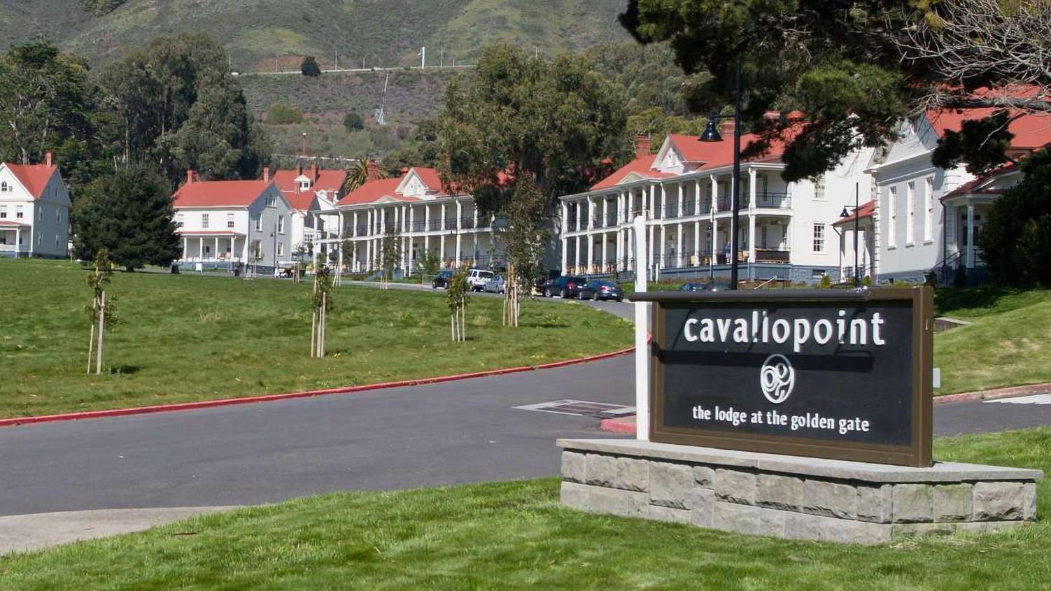 The Cavallo Point Lodge sign in a green field of grass.