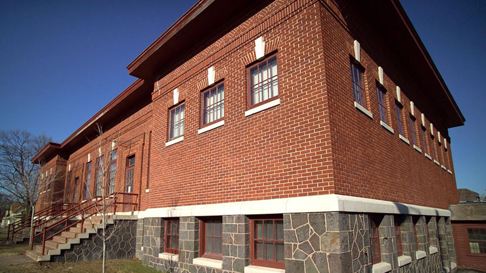 Fall scene of a two-story brick and poor-rock building