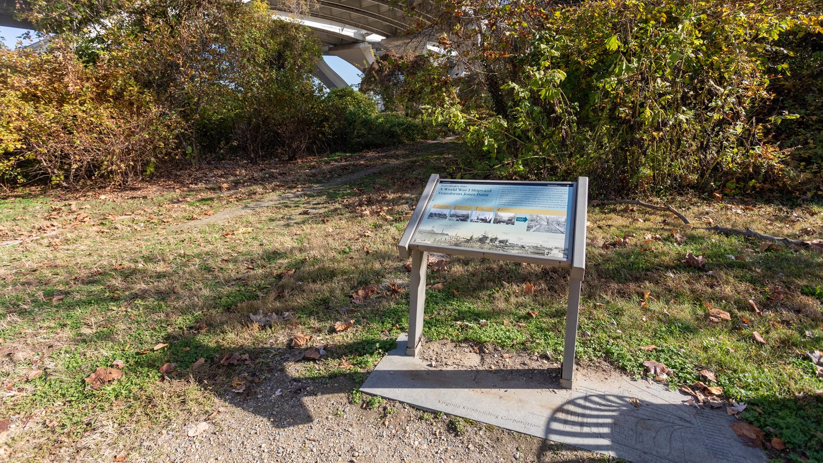 An angled information panel below a bridge.