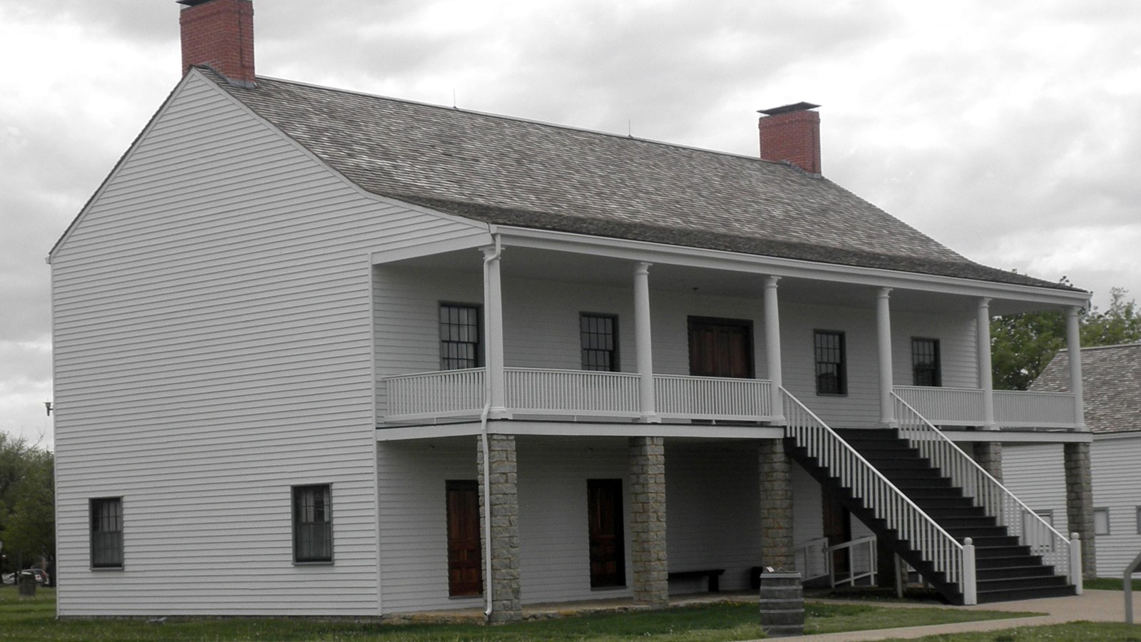 two story building with pillars and stairs