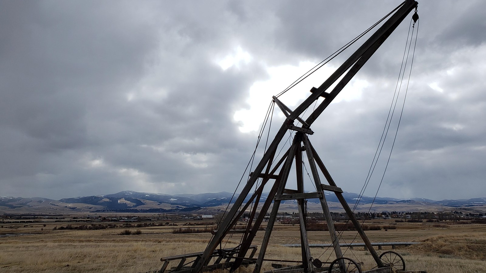 A historic wooden Jenkins hay stacker sits in a pasture at Grant-Kohrs Ranch.