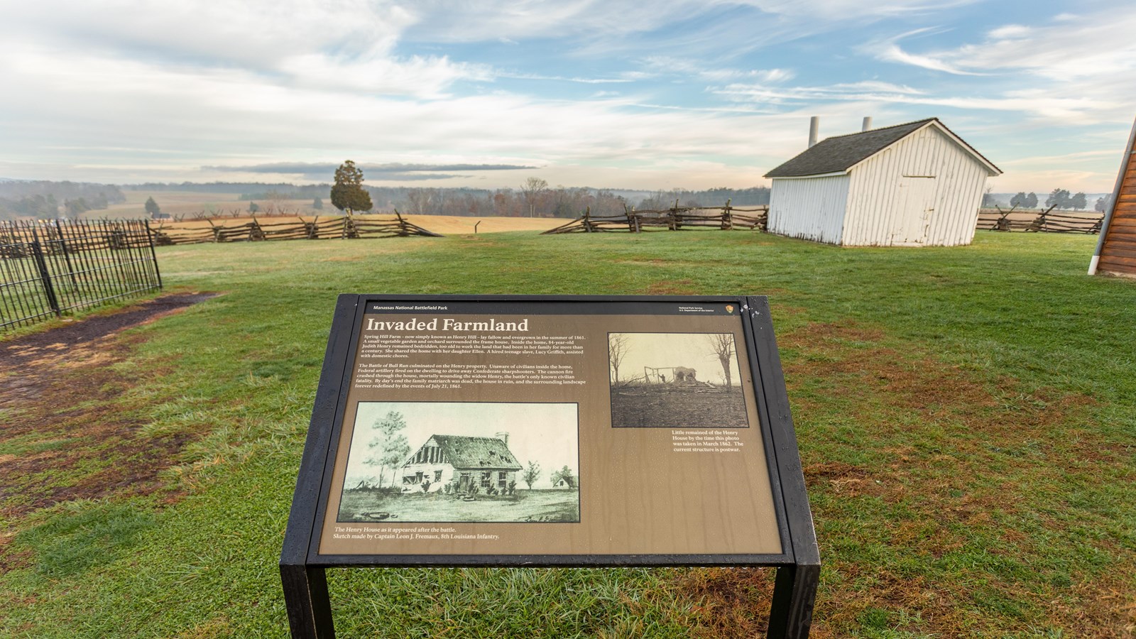 An informational panel in front of a farm. 