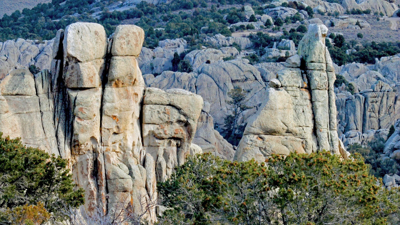 Towering granite pinnacles highlighted by sunlight at dusk.