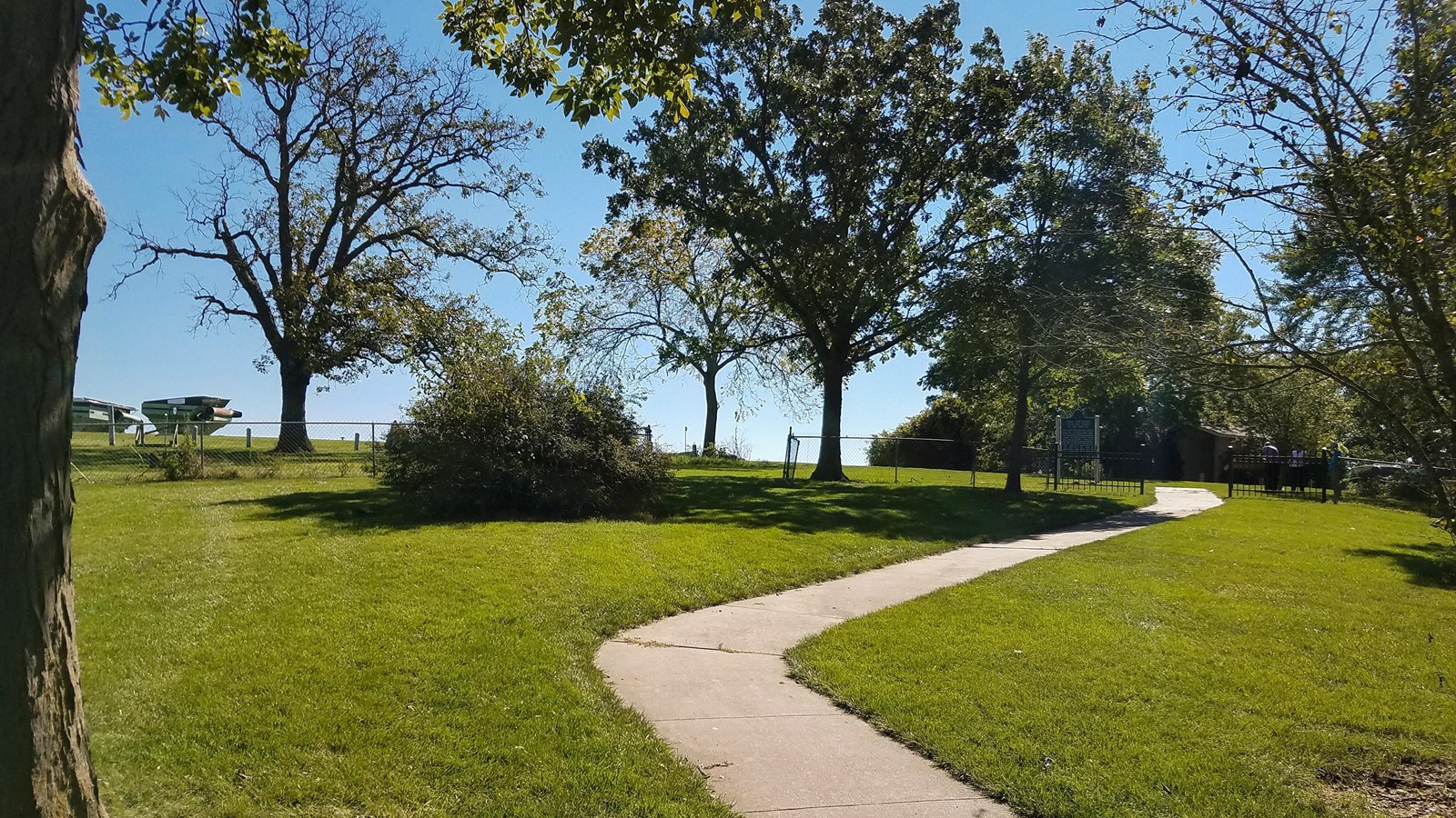 A winding path leads through a grassy park. 