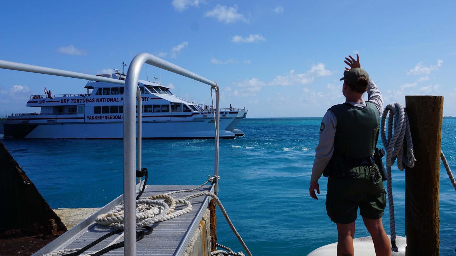 Yankee Freedom, a high speed catamaran departs Garden Key and Garden Key harbor in the afternoon.
