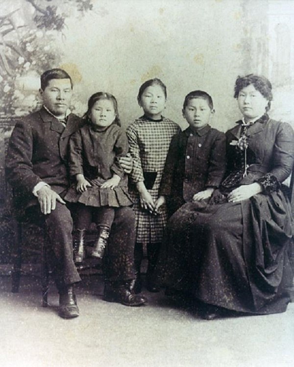 Couple seated with three children.