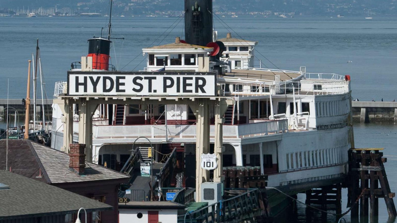  The Hyde Street Pier entry gate and sign,with the ferryboat Eureka behind.