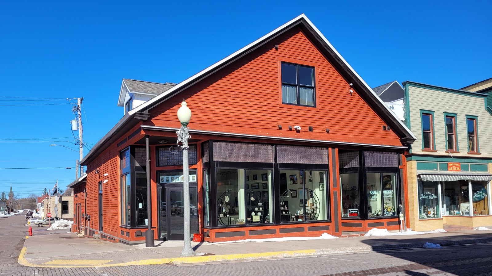 One- and one-half story building with red-orange siding.