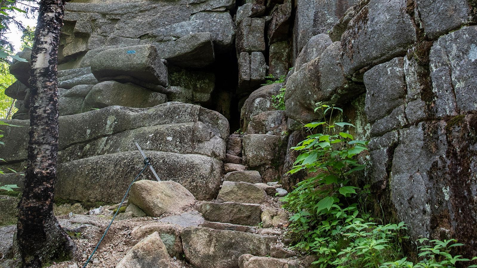 stone steps lead the path into a crack in the rocks