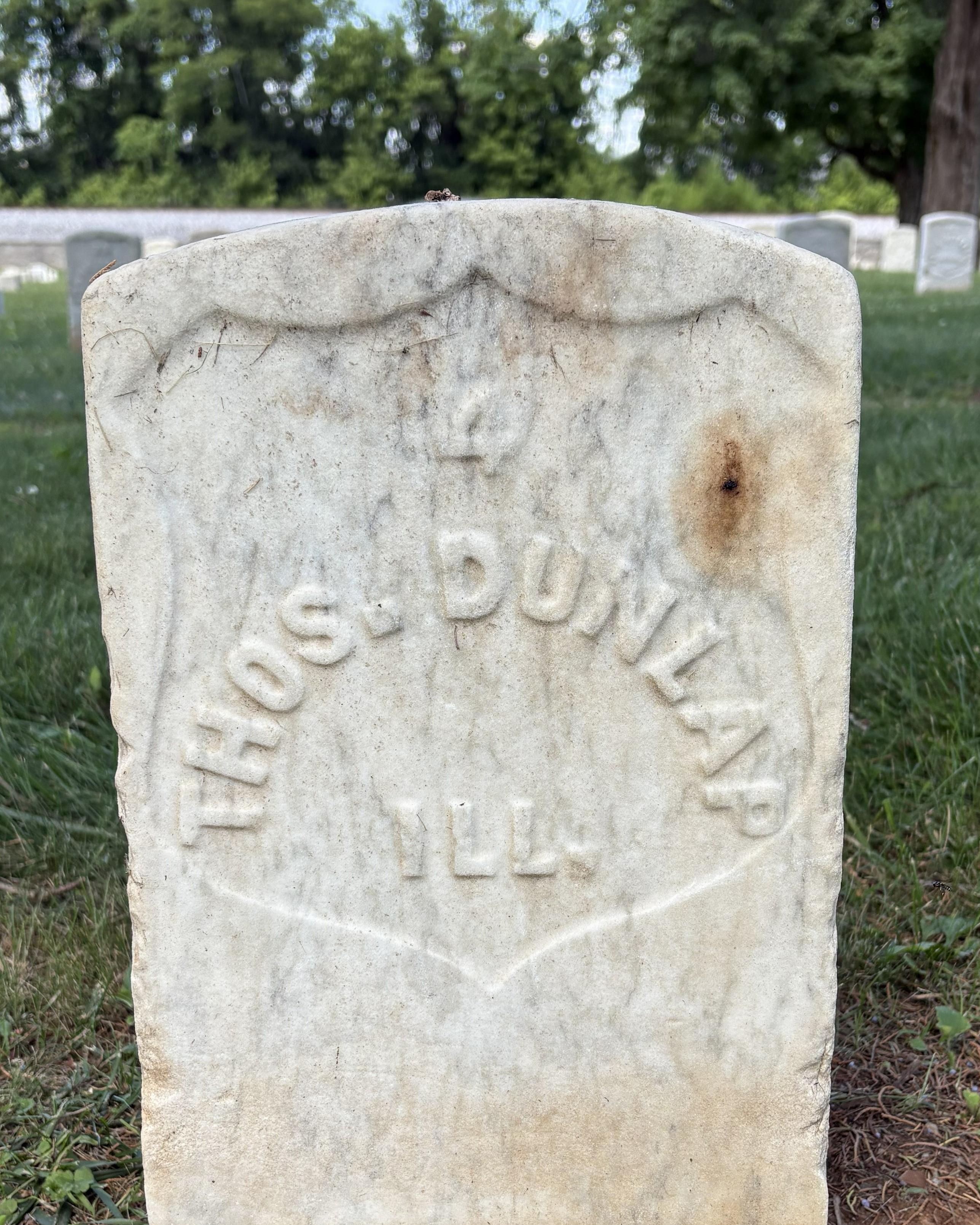 Marble headstone belonging to Civil War veteran Thos. Dunlap. 