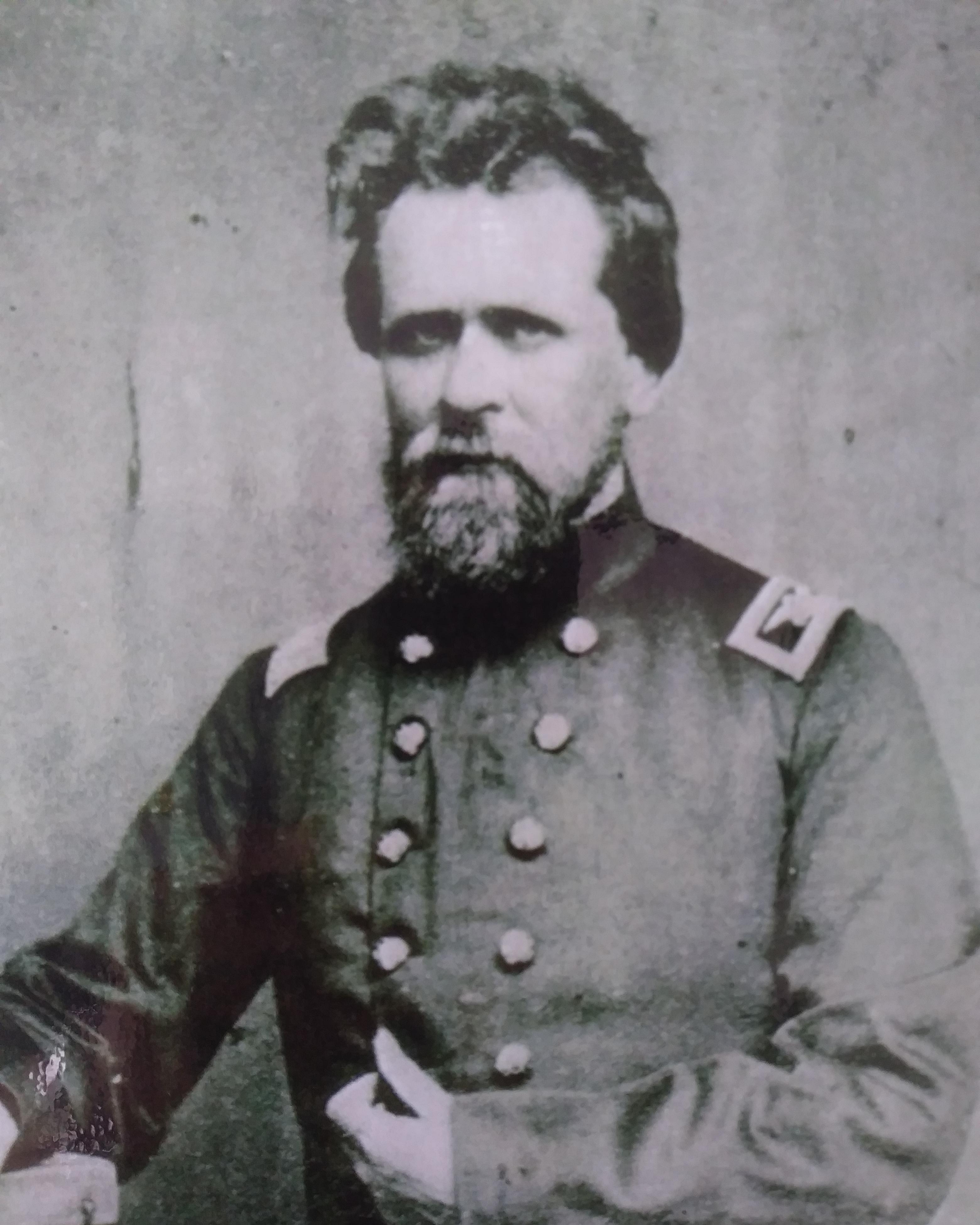 A Civil War era portrait photo shows a bearded US colonel in uniform.